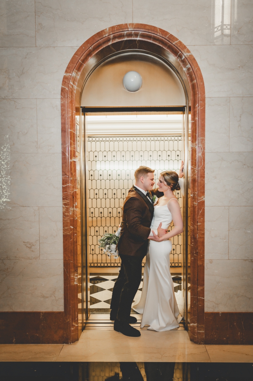 A couple in the arched doorway of The Library