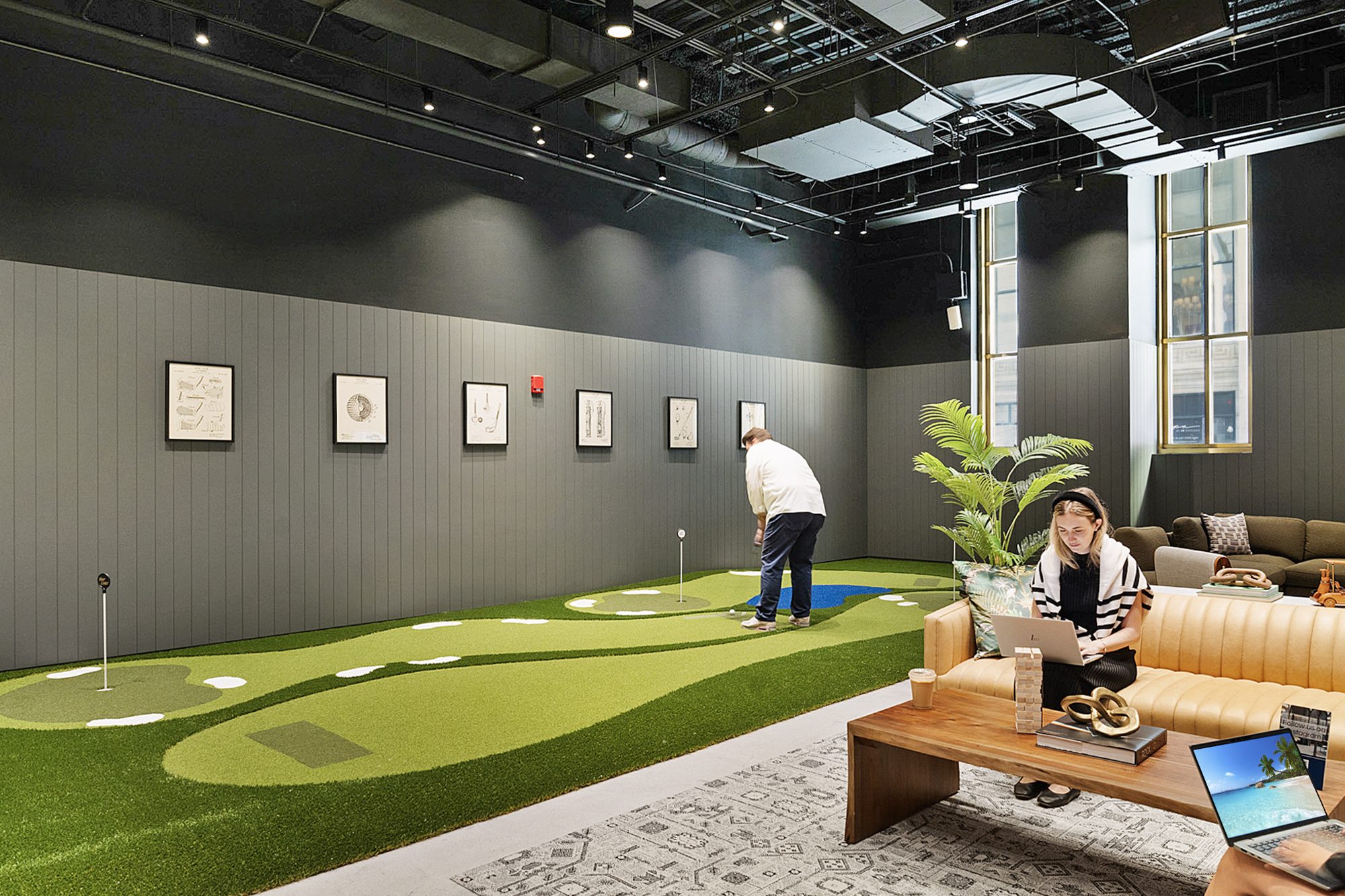 A guest putting on the indoor green at The 19th Hole