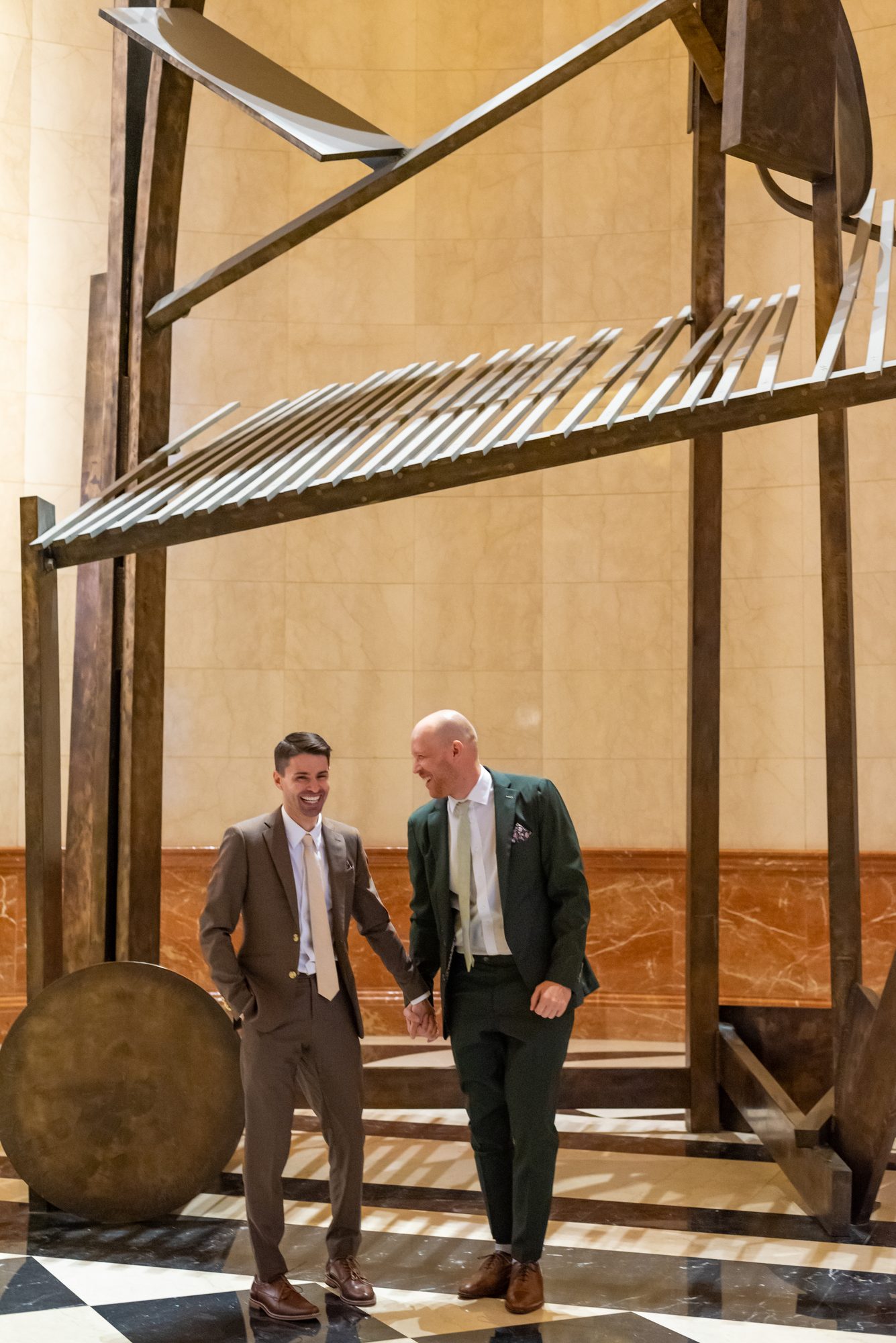 A couple photographed beside the sculpture