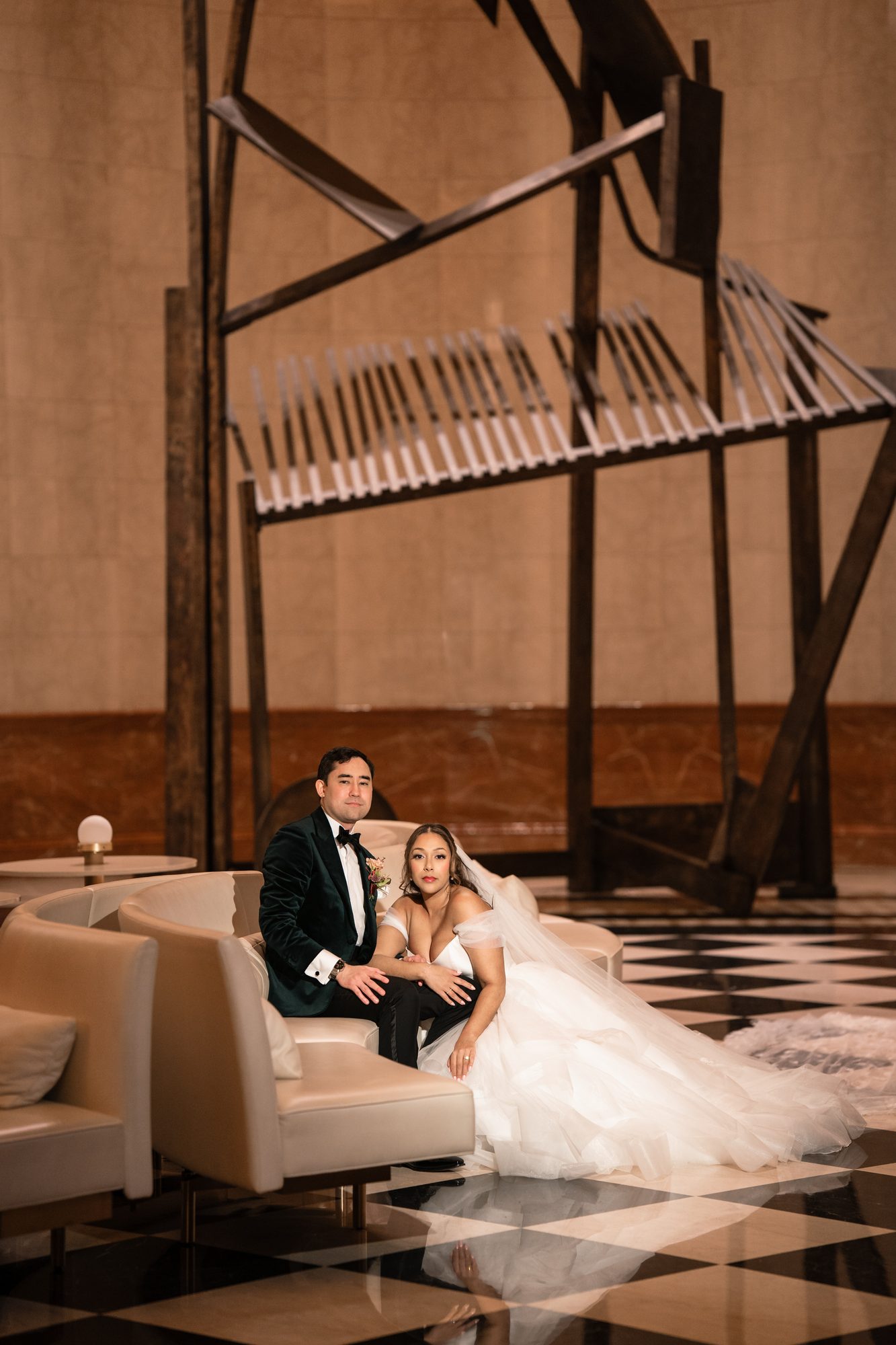 A couple seated beneath the sculpture in The Lobby