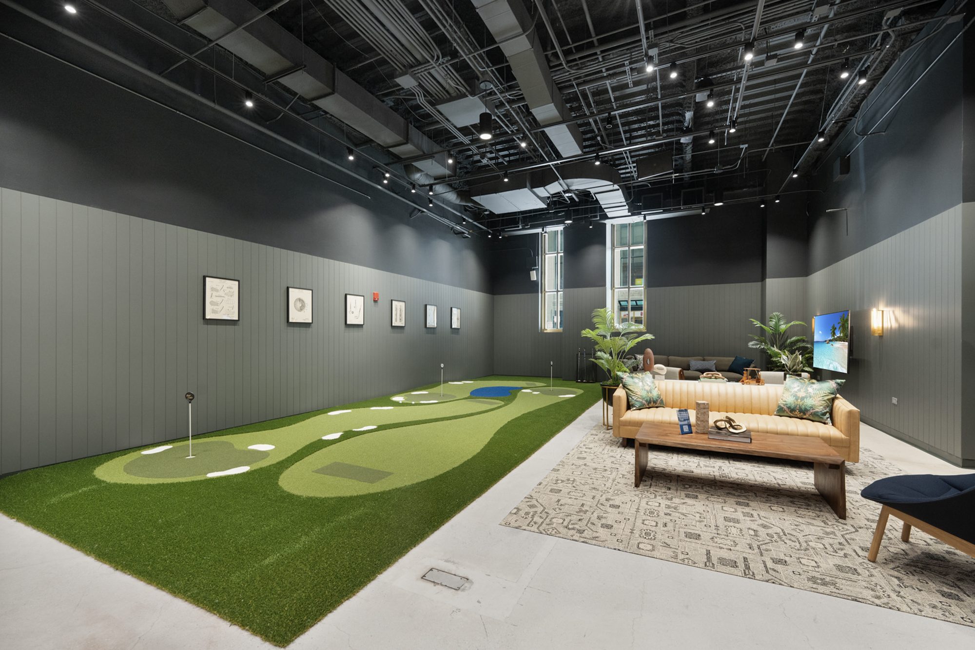 The indoor putting green and lounge seating