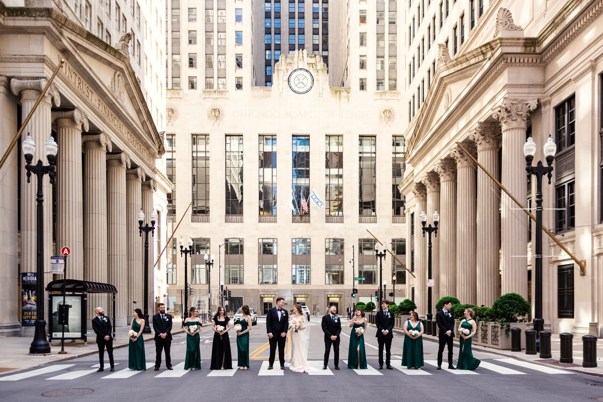 A wedding party lined up across LaSalle Street beneath the Board of Trade