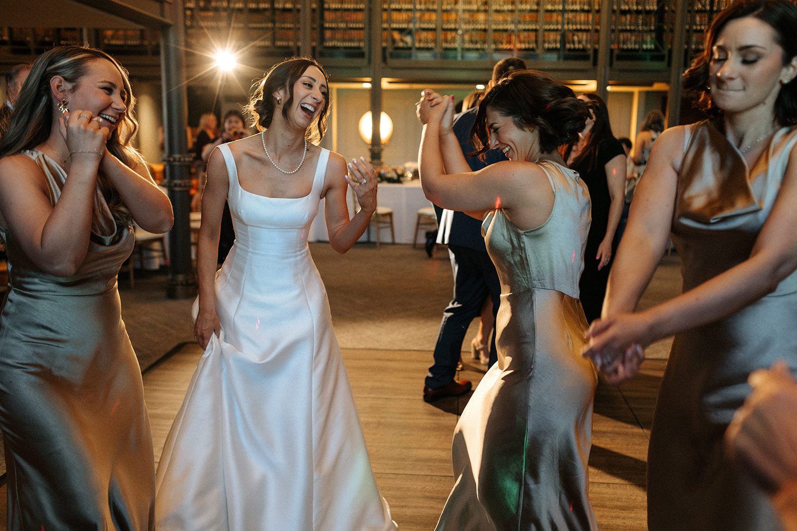 A bride dancing with her bridesmaids
