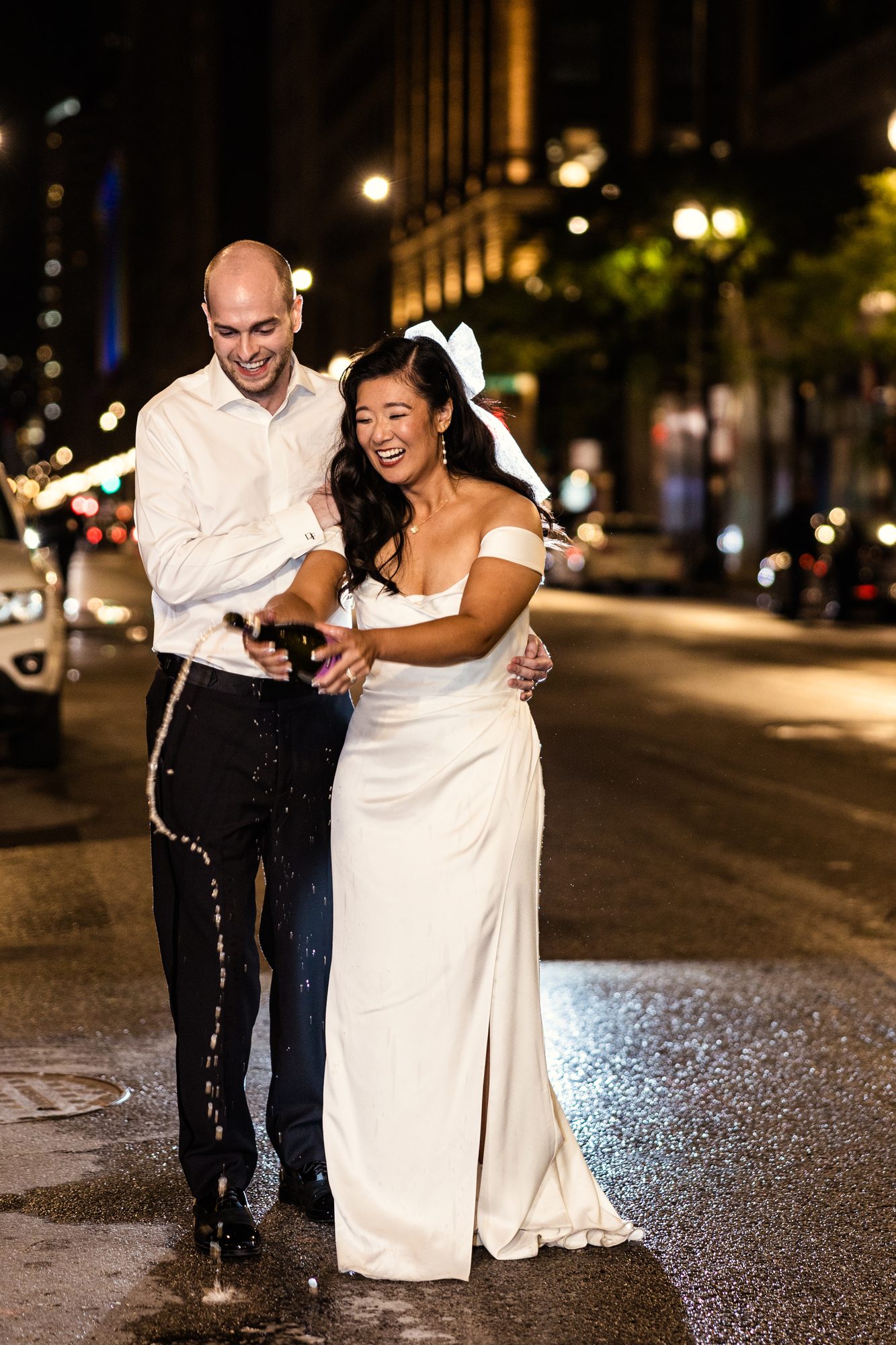 A couple celebrating on the street at night